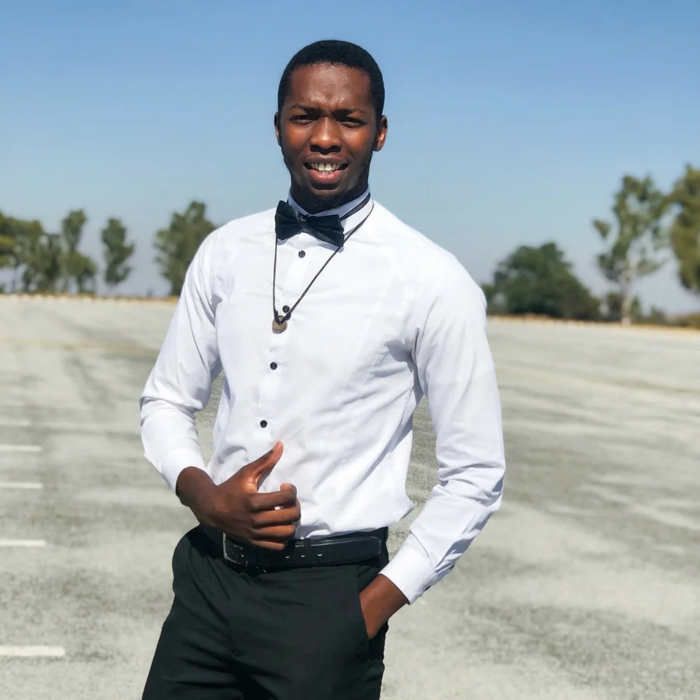 Farai chimbwedza standing in the parking lot at Midlands State University in 2019