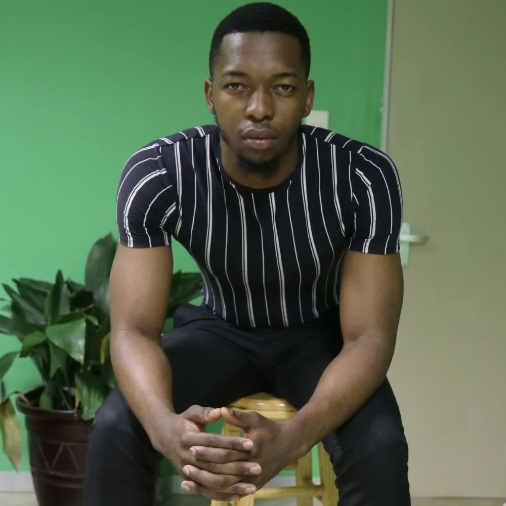 Farai Chimbwedza when he was younger sitting down at the office